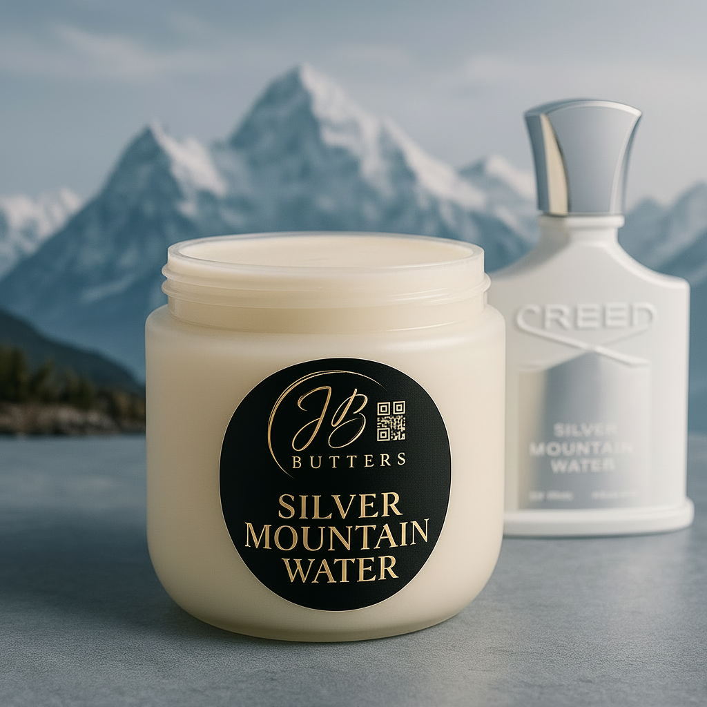 Jar of JB Butters Silver Mountain Water cream with a Creed bottle in the background, set against a mountainous landscape.