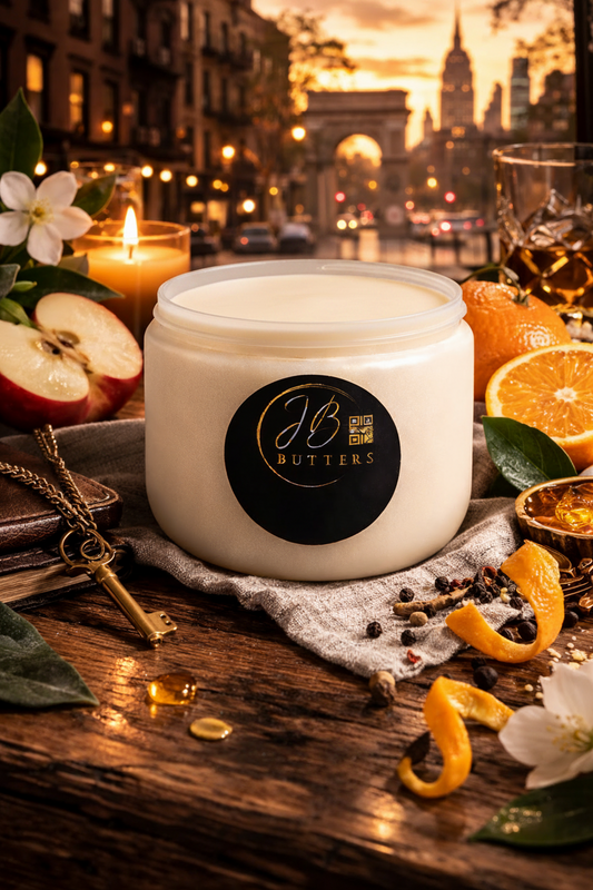 Jar of JB Butters cream on a wooden table with decorative elements and cityscape in the background