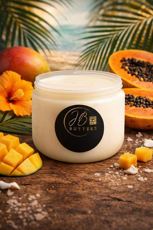 Jar of JB Butters on a wooden surface with tropical fruits and flowers