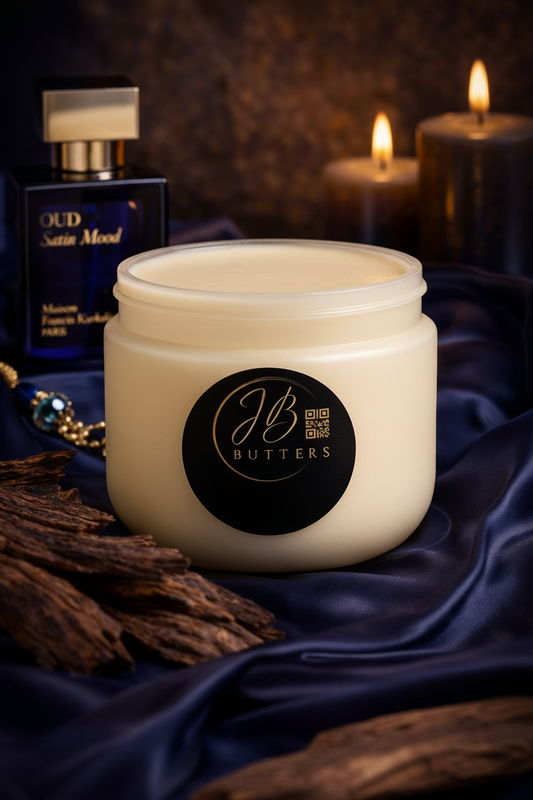 Jar of JB Butters cream with candles and a bottle in the background